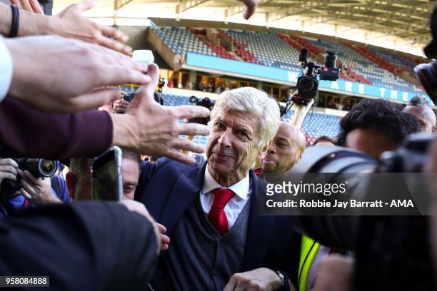 Arsene Wenger head coach / manager of Arsenal engages with the fans of Arsenal at full time after he comes back out during the Premier League match...