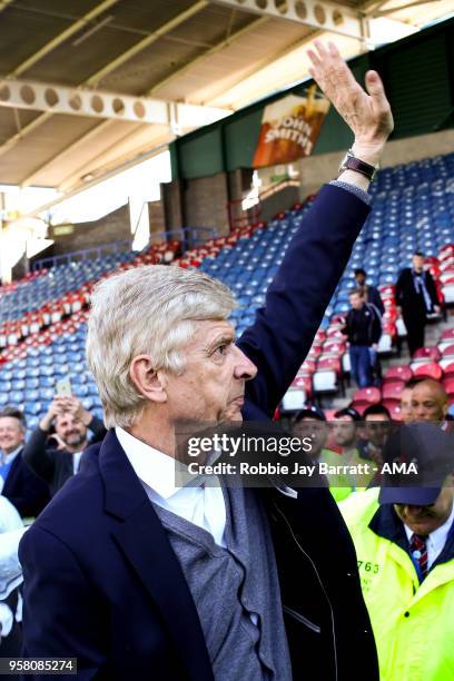 Arsene Wenger head coach / manager of Arsenal waves to the Arsenal fans at full time during the Premier League match between Huddersfield Town and...