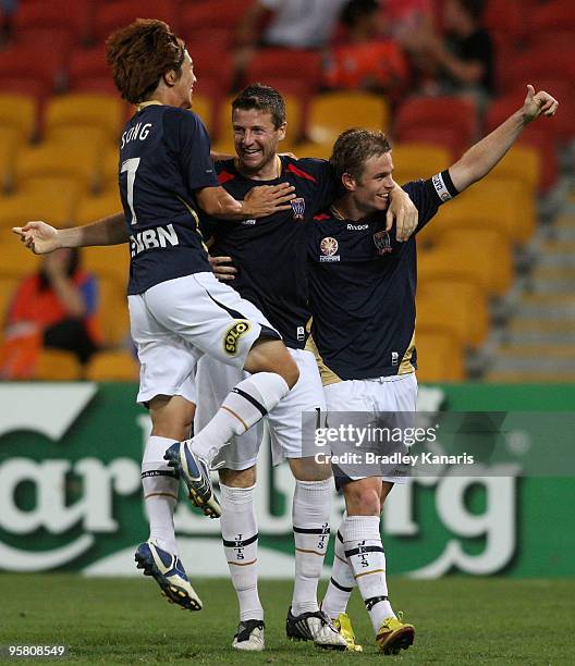 Matthew Thompson of the Jets celebrates with team mates after scoring a goal during the round 23 A-League match between the Brisbane Roar and the...