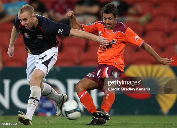 Michael Zullo of the Roar is pressured by the defence of Jobe Wheelhouse of the Jets as he shoots for goal during the round 23 A-League match between...