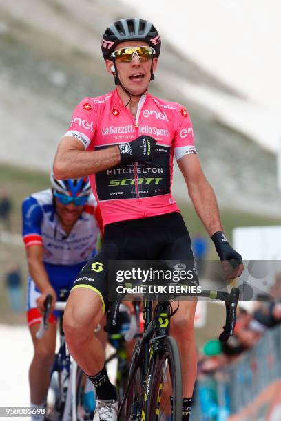 Pink jersey Britain's rider of team Mitchelton-Scott Simon Yates celebrates as he crosses the finish line to win the 9th stage between Pesco Sannita...