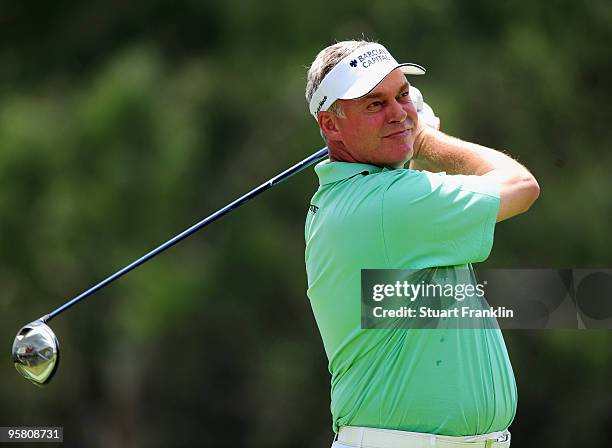 Darren Clarke of Northern Ireland plays his tee shot on the fourth hole during the third round of the Joburg Open at Royal Johannesburg and...