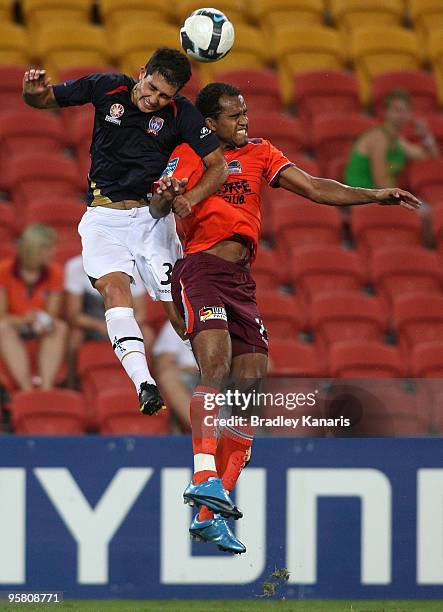 Adam D'Apuzzo of the Jets and Reinaldo of the Roar challenge for the all during the round 23 A-League match between the Brisbane Roar and the...