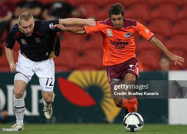 Michael Zullo of the Roar is challenged by Jobe Wheelhouse of the Jets during the round 23 A-League match between the Brisbane Roar and the Newcastle...