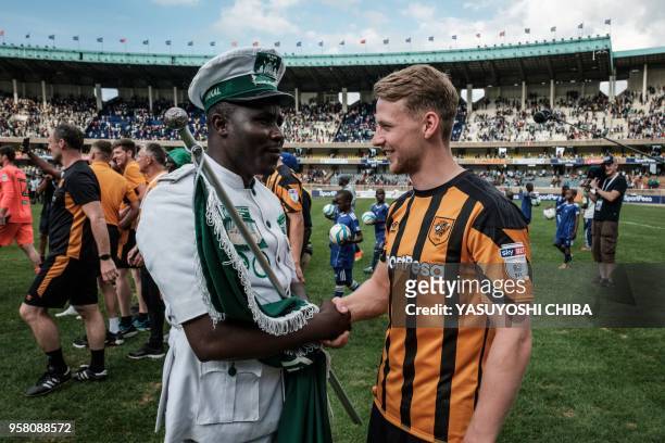 Stephen Kingsley of Englands Hull City greets a costumed supporter of Kenya's Gor Mahia after their friendly match at the Kasarani stadium in Nairobi...