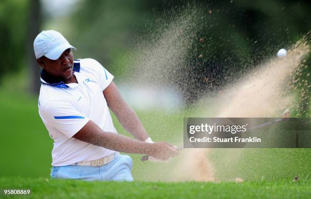 James Kamte of South Africa plays his bunker shot on the fifth hole during the third round of the Joburg Open at Royal Johannesburg and Kensington...