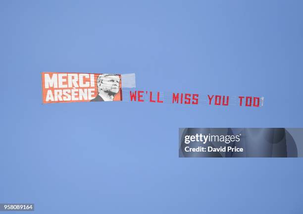 Plane flys over the stadium with an Arsene Wenger banner during the Premier League match between Huddersfield Town and Arsenal at John Smith's...