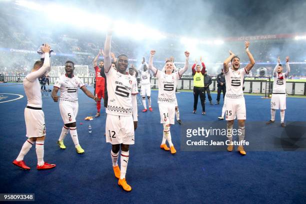 Joris Gnagnon, James Lea Siliki, Benjamin Bourigeaud, Rami Bensebaini of Rennes celebrate the victory in front of their supporters following the...