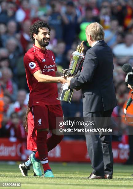 Mohamed Salah of Liverpool greeted by Kenny Dalglish with the player of the year award during the Premier League match between Liverpool and Brighton...