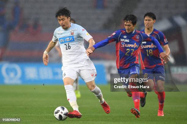 Ryota Hayasaka of Consadole Sapporo and Sotan Tanabe of FC Tokyo compete for the ball during the J.League J1 match between FC Tokyo and Consadole...