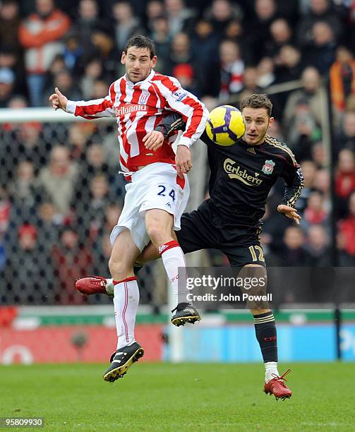 Rory Delap of Stoke goes up with Fabio Aurelio of Liverpool during the Barclays Premier League match between Stoke City and Liverpool at Britannia...