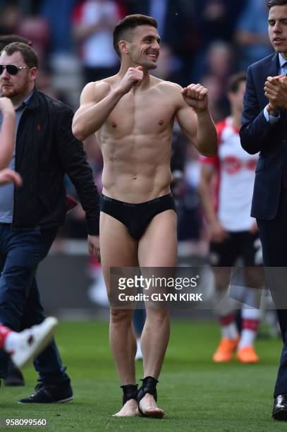 Southampton's Serbian midfielder Dusan Tadic walks on the pitch after stripping off his kit at the end the English Premier League football match...