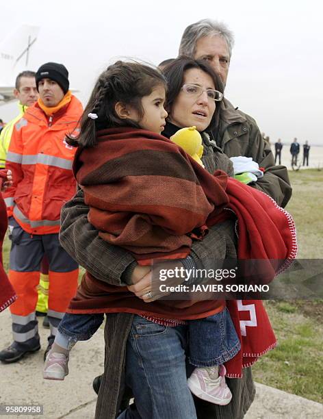 Survivors from the huge earthquake that devastated Haiti on January 12, arrive at the Torrejon de Ardoz airport in Madrid, on January 16, 2010. The...