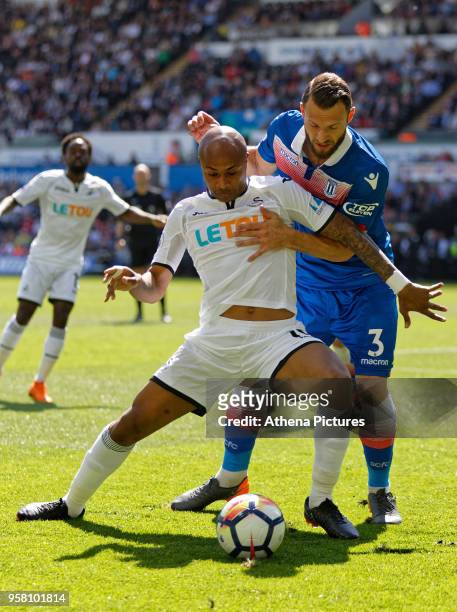 Andre Ayew of Swansea City challenged by Erik Pieters of Stoke City during the Premier League match between Swansea City and Stoke City at The...
