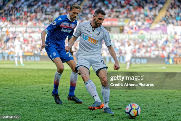 Angel Rangel of Swansea City followed by Peter Crouch of Stoke City during the Premier League match between Swansea City and Stoke City at The...