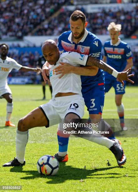 Andre Ayew of Swansea City challenged by Erik Pieters of Stoke City during the Premier League match between Swansea City and Stoke City at The...