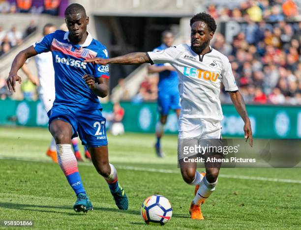 Nathan Dyer of Swansea City closely marked by Badou Ndiaye of Stoke City during the Premier League match between Swansea City and Stoke City at The...