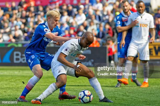 Andre Ayew of Swansea City challenged by Lasse Sorenson of Stoke City during the Premier League match between Swansea City and Stoke City at The...