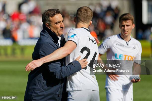 Swansea manager Carlos Carvalhal embraces Andy King of Swansea City after the end of the game during the Premier League match between Swansea City...