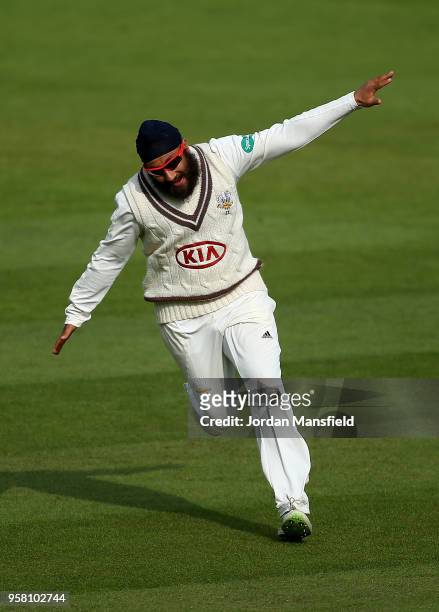 Amar Virdi of Surrey celebrates dismissing Joe Root of Yorkshire during day three of the Specsavers County Championship Division One match between...