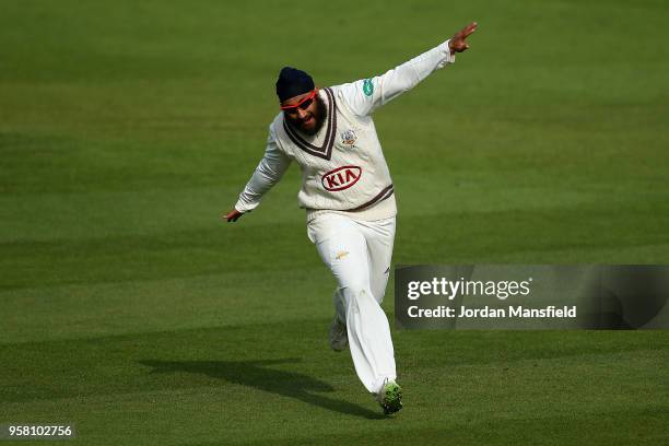 Amar Virdi of Surrey celebrates dismissing Joe Root of Yorkshire during day three of the Specsavers County Championship Division One match between...