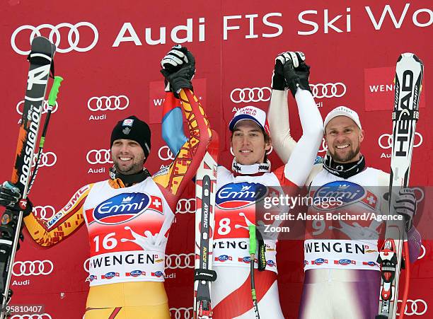 Manuel Osborne-Paradis of Canada, 2nd, Carlo Janka of Switzerland, 1st, and Marco Buechel of Liechtenstein 3rd pose on the podium during the Audi FIS...