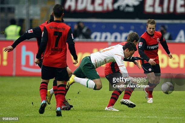 Mesut Oezil of Bremen is challenged by Pirmin Schwegler during the Bundesliga match between Eintracht Frankfurt and Werder Bremen at the Commerzbank...