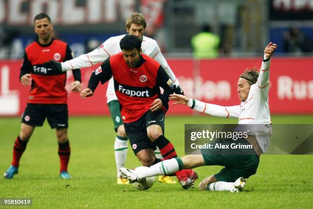 Selim Teber of Frankfurt is challenged by Clemens Fritz of Bremen during the Bundesliga match between Eintracht Frankfurt and Werder Bremen at the...