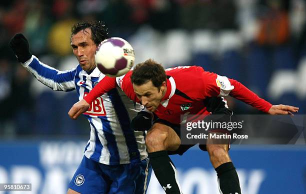 Steven Cherundolo of Hannover 96 and Theofanis Gekas of Berlin compete for the ball during the Bundesliga match between Hannover 96 and Hertha BSC...