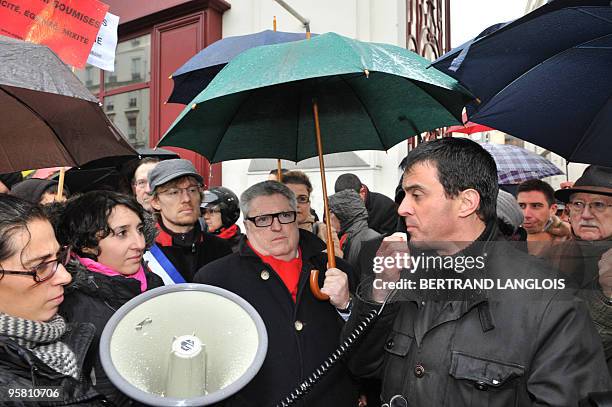 French MP Manuel Valls speaks beside the president of the Women's rights associations "Ni putes ni soumises" Sihem Habchi during a protest on January...