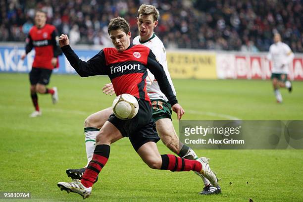 Pirmin Schwegler of Frankfurt is challenged by Per Mertesacker of Bremen during the Bundesliga match between Eintracht Frankfurt and Werder Bremen at...