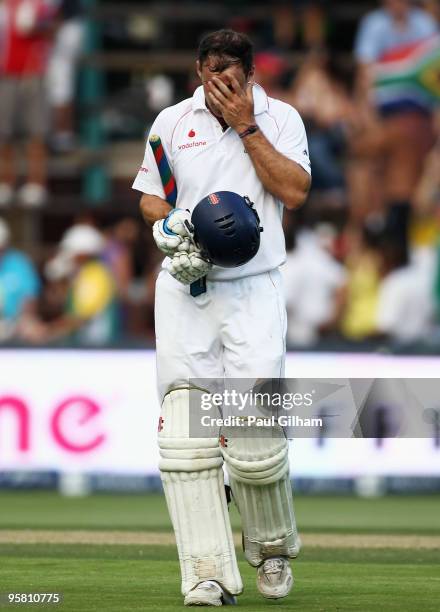 Captain Andrew Strauss of England holds his head as he walks off after losing his wicket to Wayne Parnell of South Africa for lbw and 22 runs during...