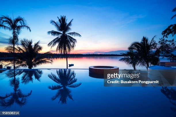 luxury swimming pool at sunset - リゾート地 ストックフォトと画像