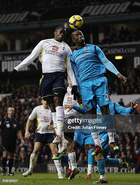 Sebastien Bassong of Tottenham Hotspur is challenged by Kamil Zayatte of Hull City during the Barclays Premier League match between Tottenham Hotspur...