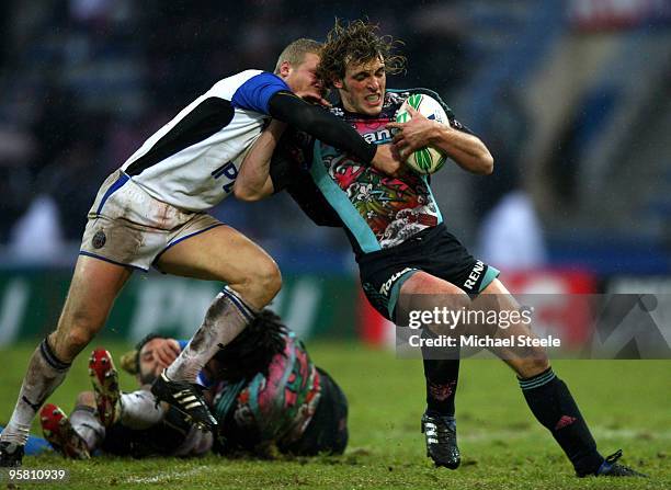 Mirco Bergamasco of Stade Francais is held up by Michael Stephenson of Bath during the Stade Francais v Bath Heineken Cup Pool 4 match at the Stade...