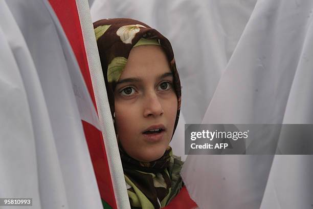 Pro-Palestinian demonstrator look son in Ankara on January 16, 2010 during a protest to accuse Israeli Defence Minister Ehud Barak of genocide and...