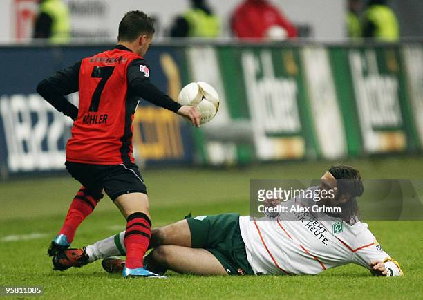 Benjamin Koehler of Frankfurt is challenged by Torsten Frings of Bremen during the Bundesliga match between Eintracht Frankfurt and Werder Bremen at...
