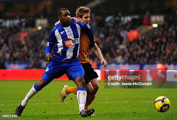 Kevin Doyle of Wolves battles with Titus Bramble of Wigan during the Barclays Premier League match between Wolverhampton Wanderers and Wigan Athletic...
