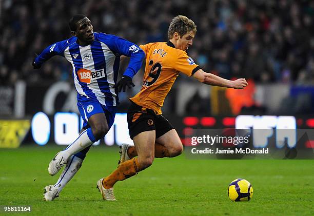 Kevin Doyle of Wolves battles with Thomas Hendry of Wigan during the Barclays Premier League match between Wolverhampton Wanderers and Wigan Athletic...