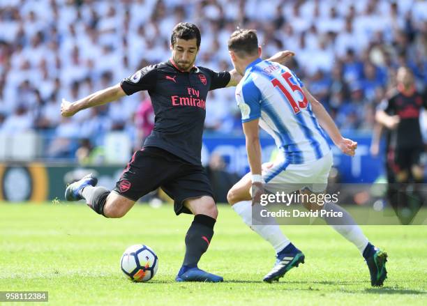 Henrikh Mkhitaryan of Arsenal shoots under pressure from Chris Lowe of Huddersfield during the Premier League match between Huddersfield Town and...