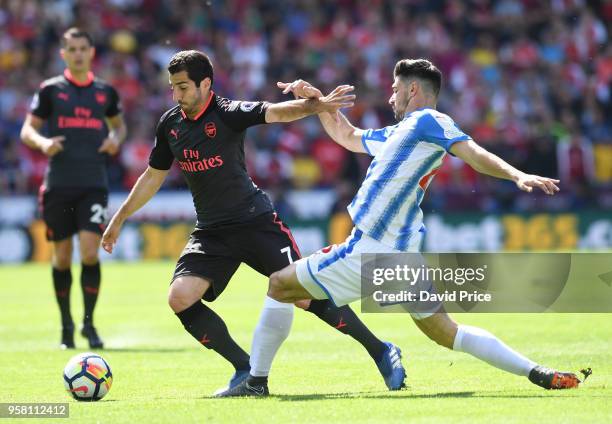 Henrikh Mkhitaryan of Arsenal takes on Christopher Schindler of Huddersfield during the Premier League match between Huddersfield Town and Arsenal at...