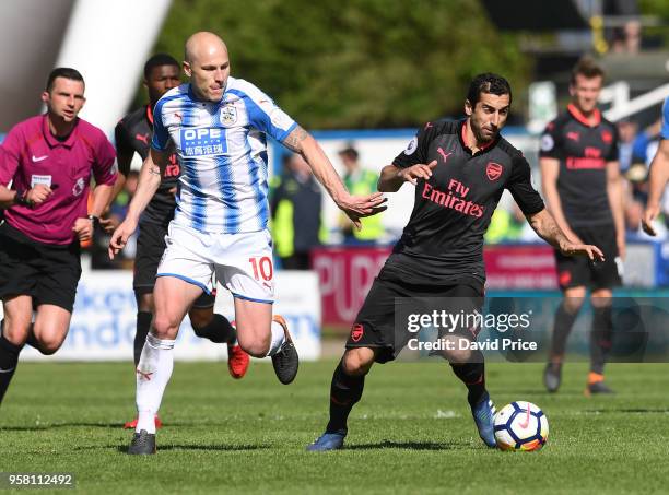 Henrikh Mkhitaryan of Arsenal takes on Aaron Mooy of Huddersfield during the Premier League match between Huddersfield Town and Arsenal at John...