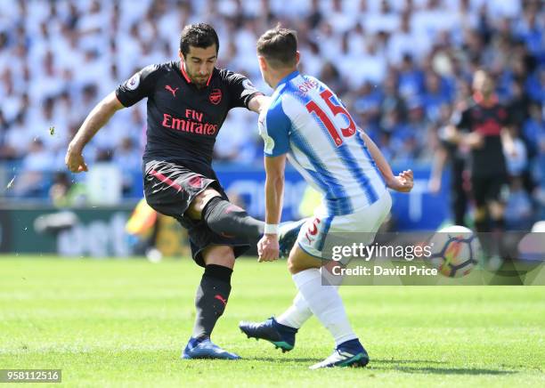 Henrikh Mkhitaryan of Arsenal shoots under pressure from Chris Lowe of Huddersfield during the Premier League match between Huddersfield Town and...