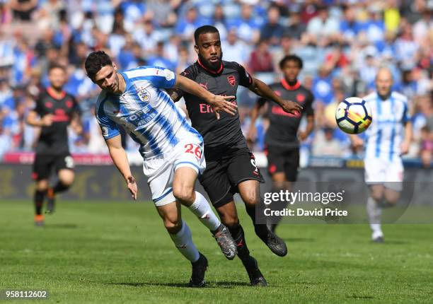 Alexandre Lacazette of Arsenal challenges Christopher Schindler of Huddersfield during the Premier League match between Huddersfield Town and Arsenal...
