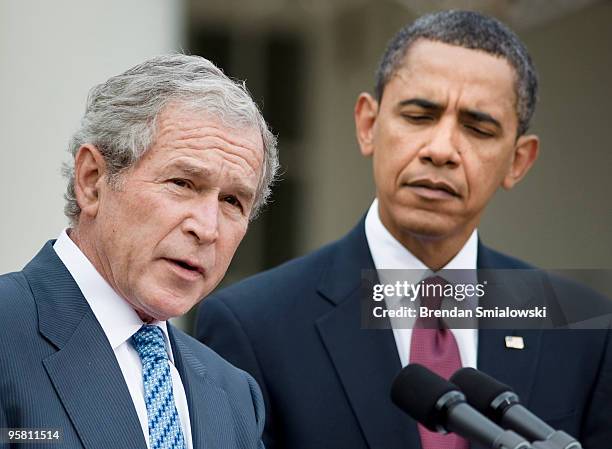 President Barack Obama listens as President George W. Bush speaks during a press conference in the Rose Garden of the White House January 16, 2010....