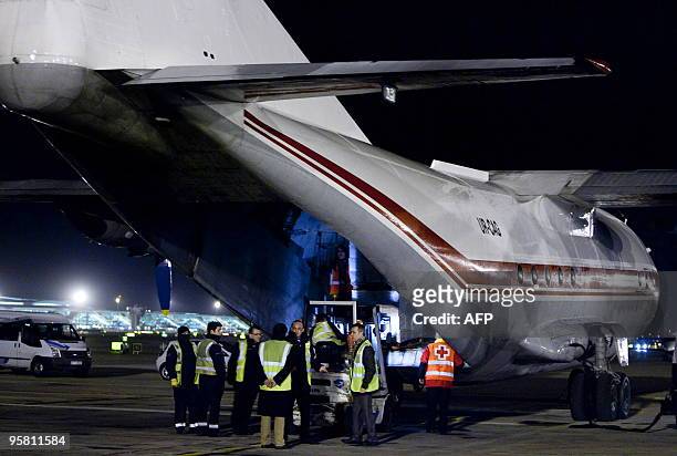 Humanitarian material is loaded on a plane chartered by the Spanish Red Cross ready to take off from Barcelona's airport to Haiti on January 15,...