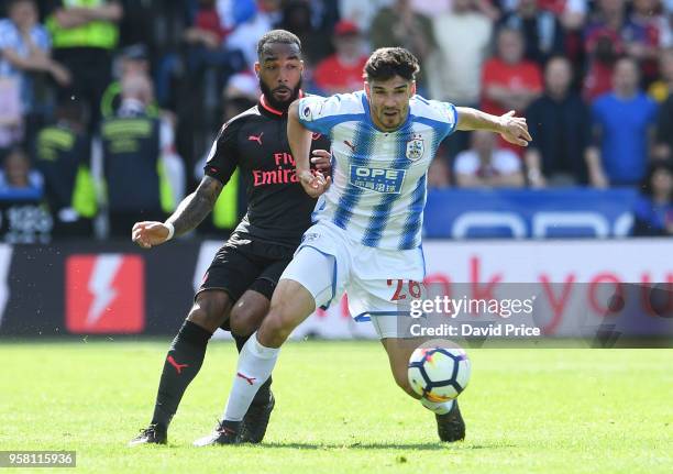 Alexandre Lacazette of Arsenal passes under pressure from Christopher Schindler of Huddersfield during the Premier League match between Huddersfield...