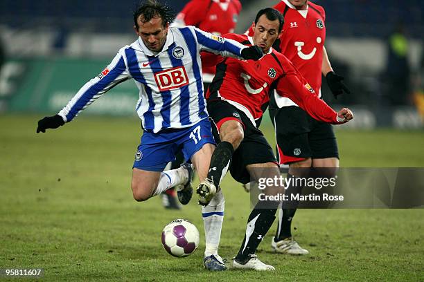 Pinto of Hannover 96 and Theofanis Gekas of Berlin compete for the ball during the Bundesliga match between Hannover 96 and Hertha BSC Berlin at the...