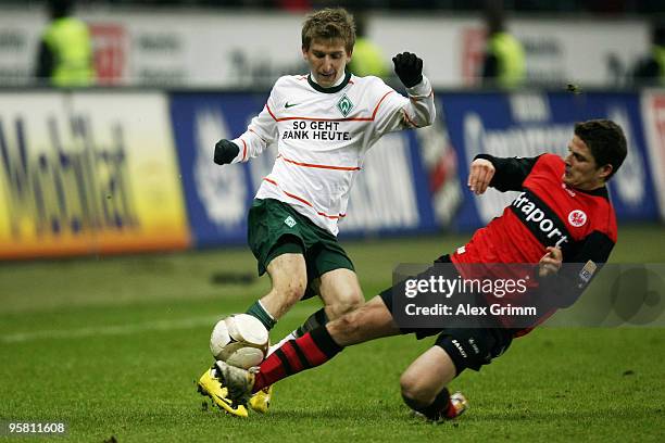 Marko Marin of Bremen is challenged by Pirmin Schwegler of Frankfurt during the Bundesliga match between Eintracht Frankfurt and Werder Bremen at the...