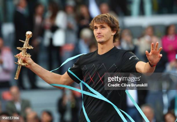 Alexander Zverev of Germany holds his winners trophy aloft after his straight sets victory against Dominic Thiem of Austria in the mens final during...